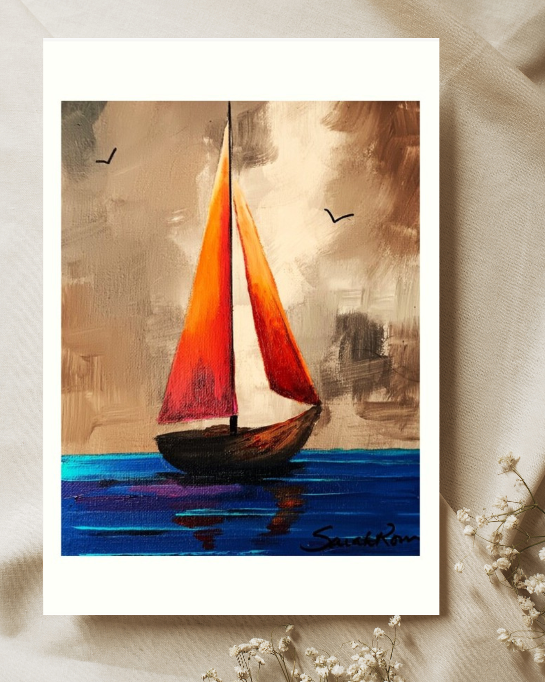 Textured acrylic painting of a small sailboat with bright red and orange sails drifting on deep blue water under a cloudy, moody sky